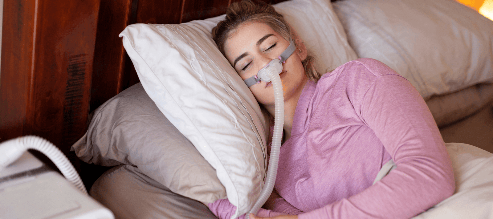woman sleeping calmly with CPAP and how mouth tape can help