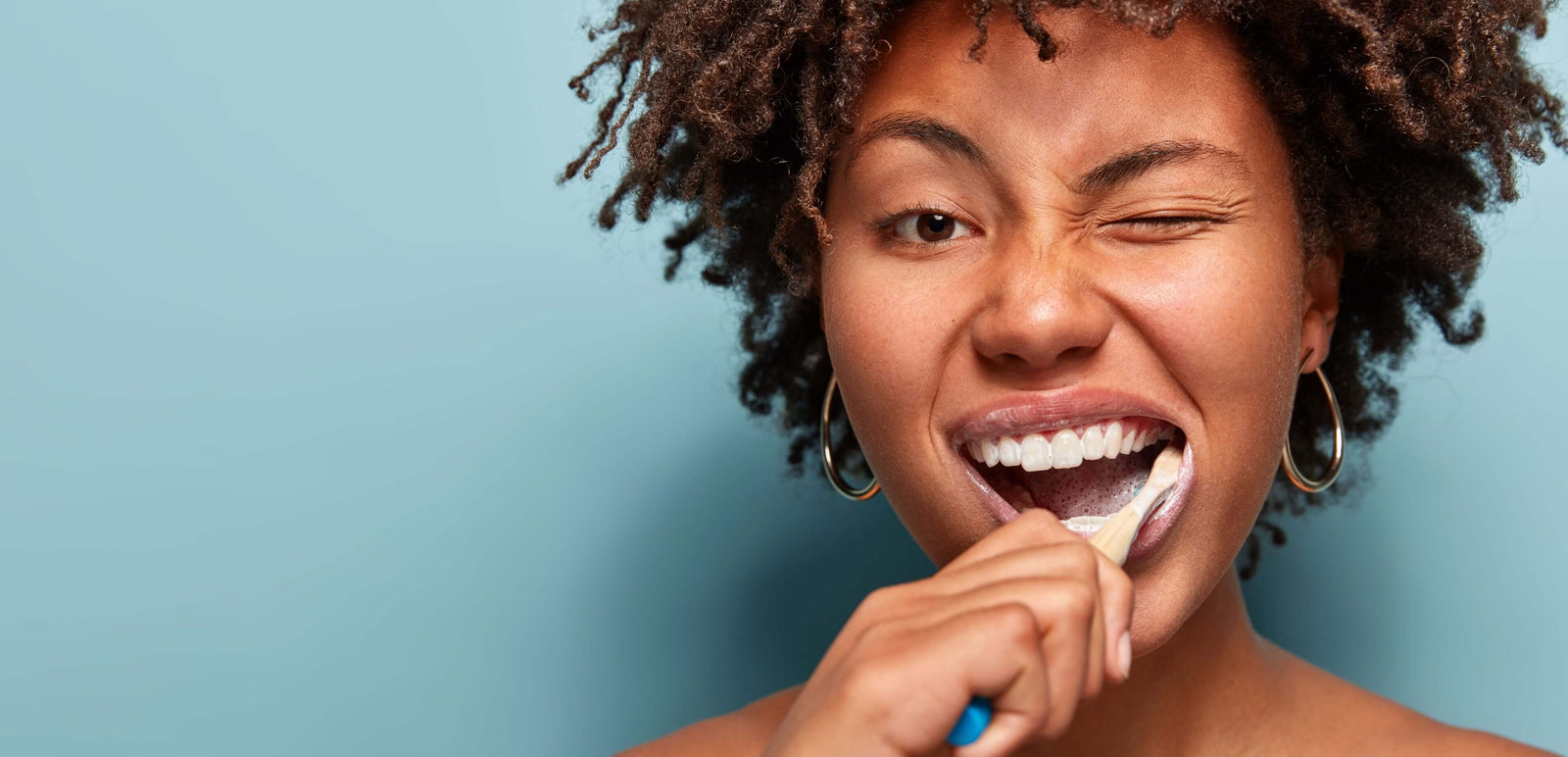 Woman brushing teeth for good oral hygiene.