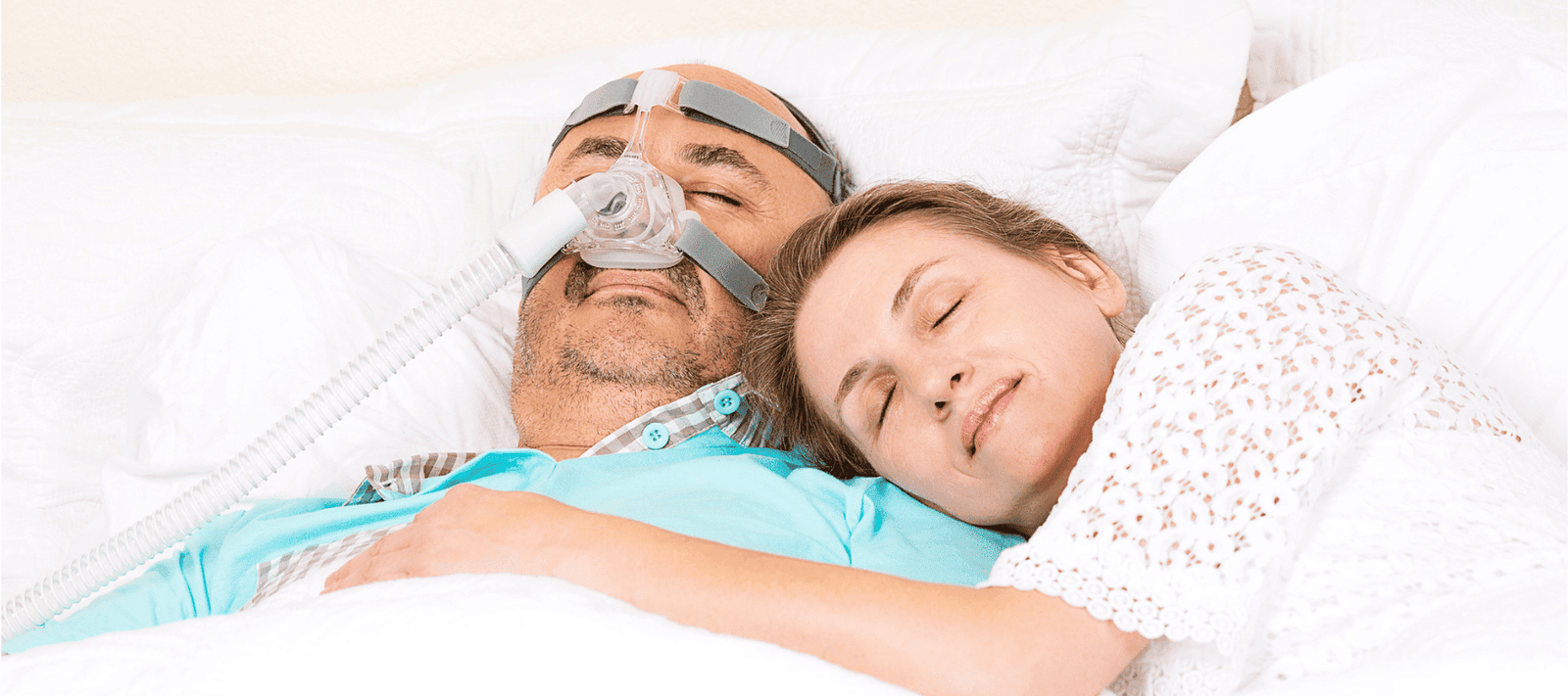 man sleeping with CPAP and the benefits of using mouth tape for sleep