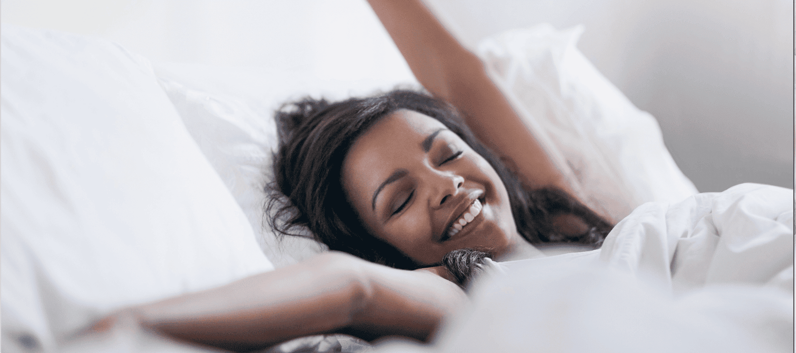 woman waking up rested because of using hypoallergenic mouth tape